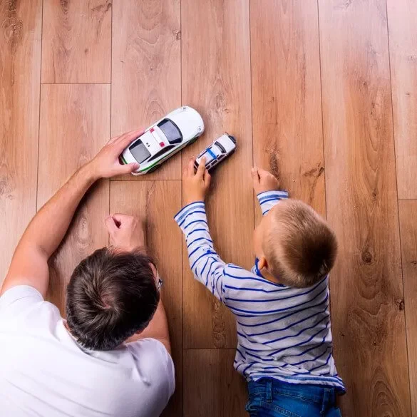 Dad son playing with toy car | Westport Flooring and Interiors